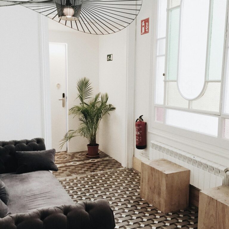 Elegant living room with geometric flooring, plush sofa, and tasteful decor.
