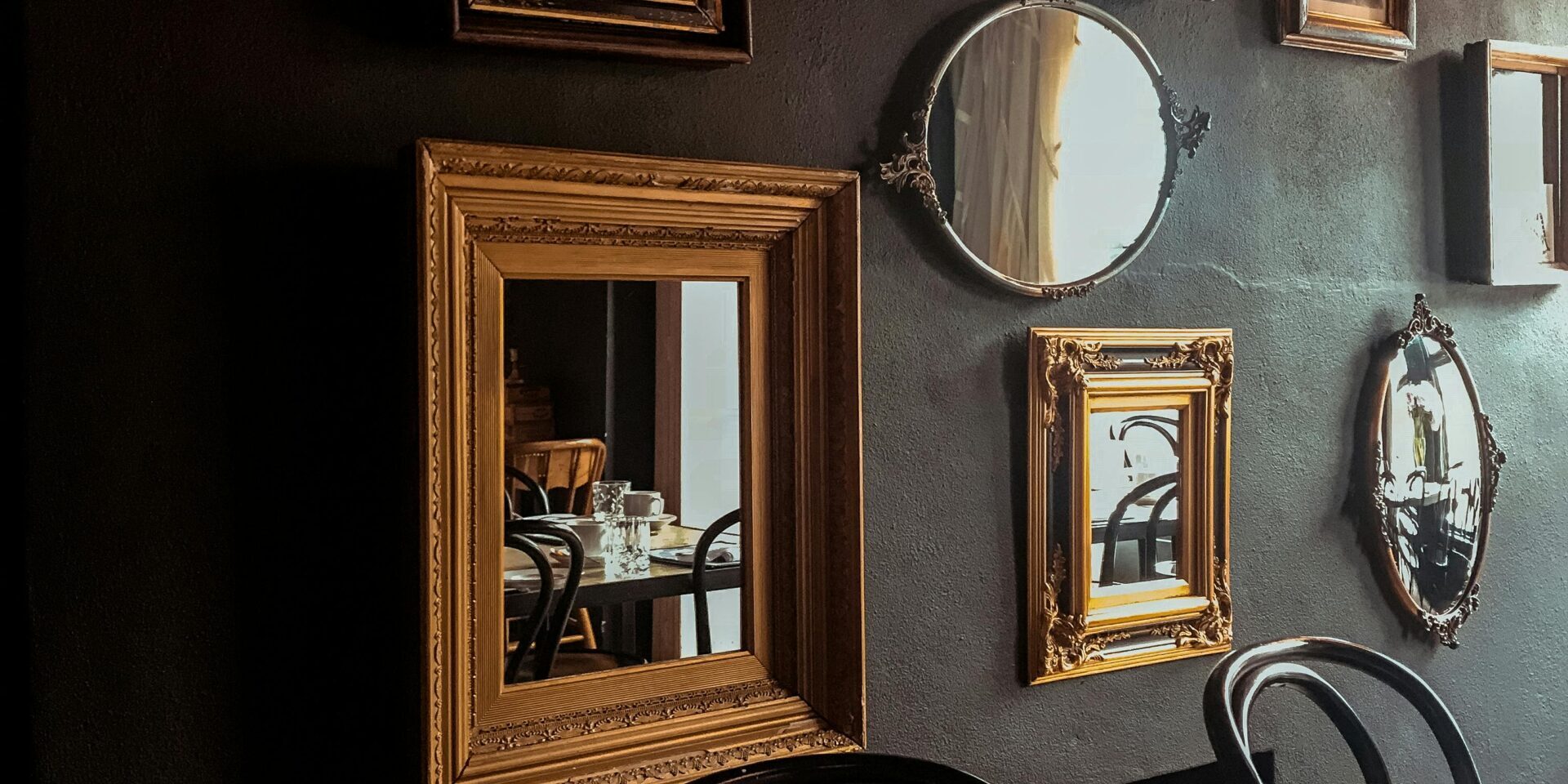 Cozy dining room with vintage mirrors and elegant table setting.