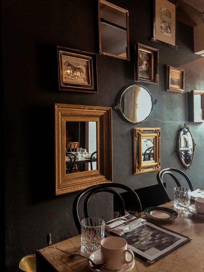 Cozy dining room with vintage mirrors and elegant table setting.