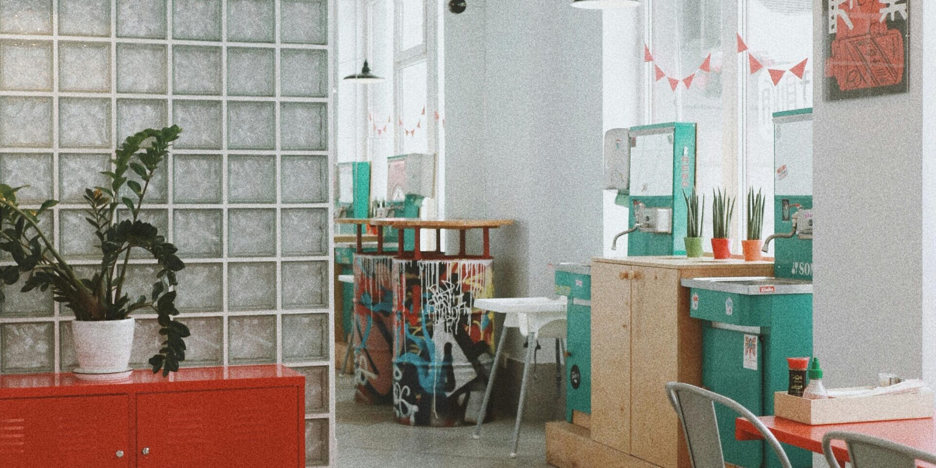 Spacious modern café interior in Kyiv with colorful decor and natural light.