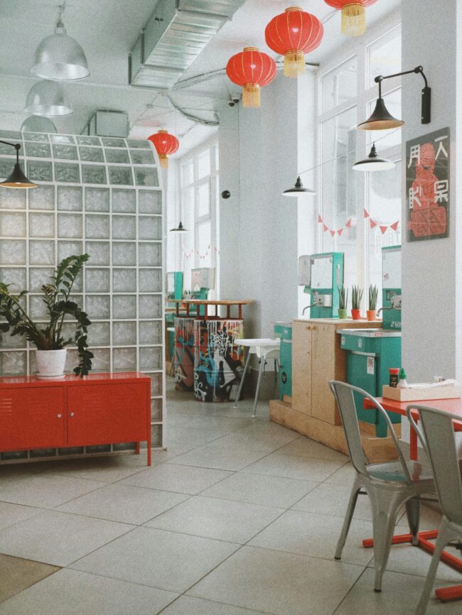 Spacious modern café interior in Kyiv with colorful decor and natural light.